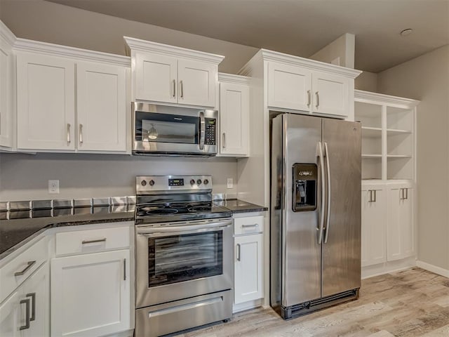 11300 N Pennsylvania Ave Unit 120, Oklahoma City, OK 73120 - kitchen featuring appliances with stainless steel finishes, white cabinets, light wood-style floors, and dark stone counters