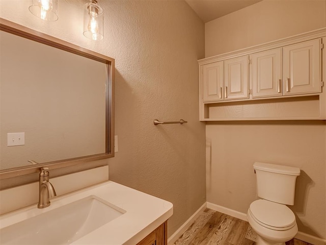 11300 N Pennsylvania Ave Unit 120, Oklahoma City, OK 73120 - half bathroom featuring vanity and wood finished floors