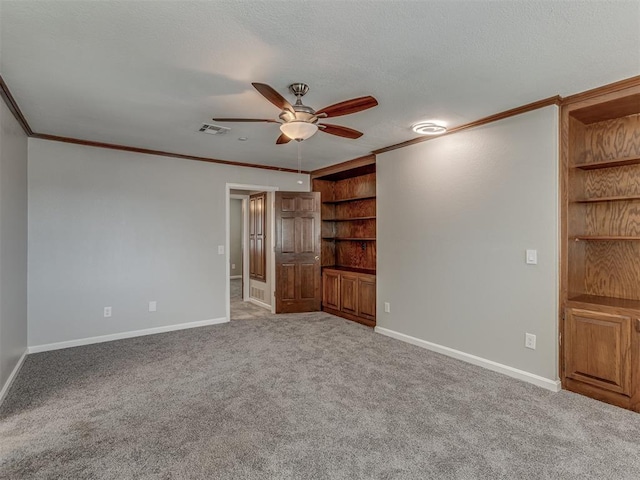 11300 N Pennsylvania Ave Unit 120, Oklahoma City, OK 73120 - unfurnished room featuring a ceiling fan, crown molding, carpet flooring, and built in features
