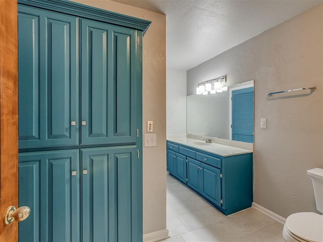 11300 N Pennsylvania Ave Unit 120, Oklahoma City, OK 73120 - bathroom with vanity, tile patterned floors, a textured wall, and a textured ceiling