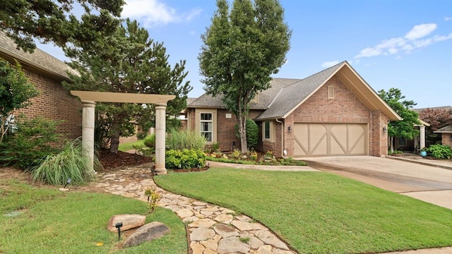 704 Capri Pl, Edmond, OK 73034 - single story home featuring brick siding, an attached garage, concrete driveway, a front lawn, and roof with shingles