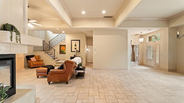 704 Capri Pl, Edmond, OK 73034 - living room featuring stairway, a fireplace, crown molding, and ceiling fan