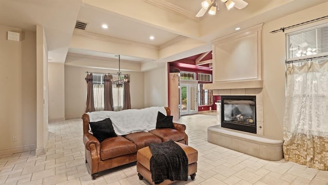 704 Capri Pl, Edmond, OK 73034 - living room with ornamental molding, a ceiling fan, a fireplace, recessed lighting, and stone tile floors