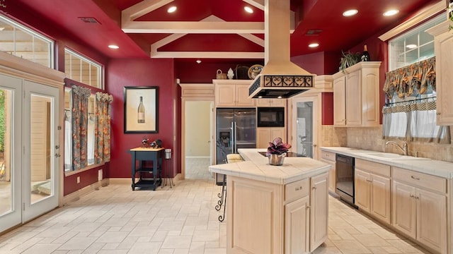 704 Capri Pl, Edmond, OK 73034 - kitchen with tile countertops, black appliances, backsplash, recessed lighting, and a center island