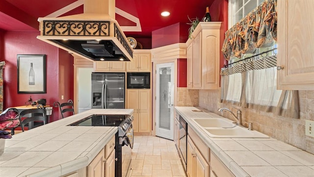 704 Capri Pl, Edmond, OK 73034 - kitchen featuring tile counters, appliances with stainless steel finishes, light brown cabinetry, stone tile floors, and recessed lighting