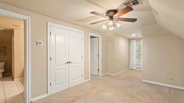 704 Capri Pl, Edmond, OK 73034 - unfurnished bedroom featuring lofted ceiling, a closet, ceiling fan, and light carpet