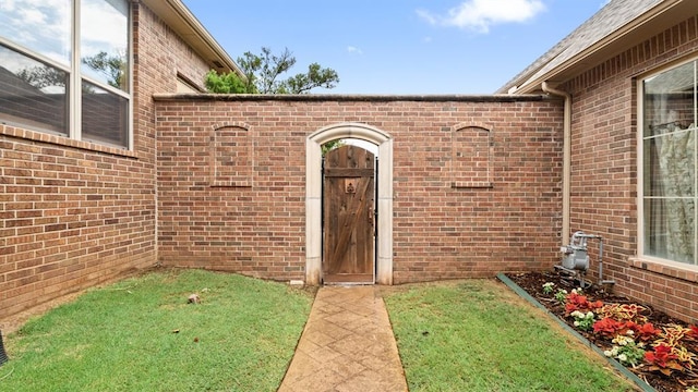 704 Capri Pl, Edmond, OK 73034 - property entrance with brick siding and a yard