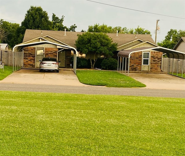 5712 NW 42nd Ter, Warr Acres, OK 73122 - view of front of house featuring a carport, a shingled roof, brick siding, and driveway