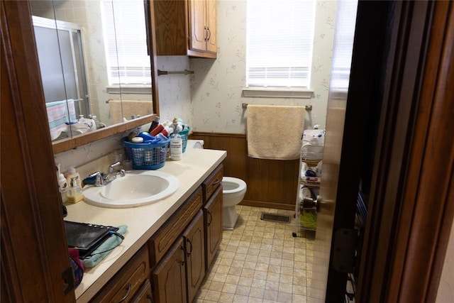5712 NW 42nd Ter, Warr Acres, OK 73122 - bathroom with a wainscoted wall, vanity, wallpapered walls, and wood walls