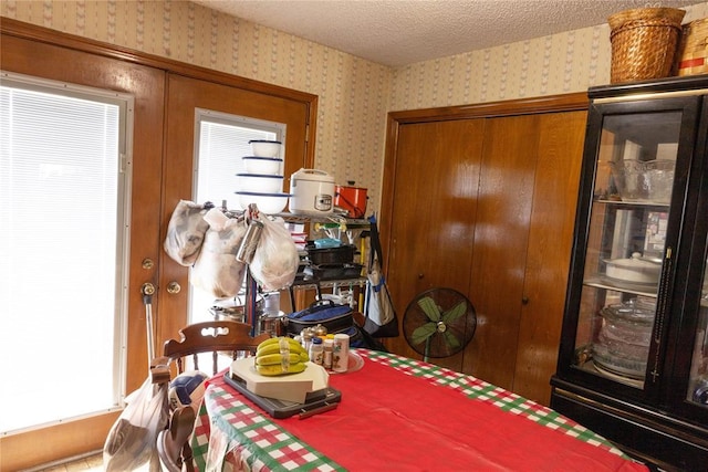 5712 NW 42nd Ter, Warr Acres, OK 73122 - dining area with wallpapered walls, healthy amount of natural light, and a textured ceiling