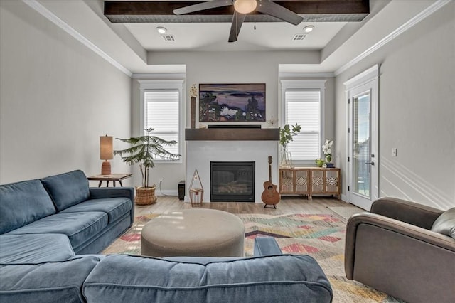 2033 Marsala Dr, Edmond, OK 73034 - living area with a glass covered fireplace, wood finished floors, a ceiling fan, and beam ceiling