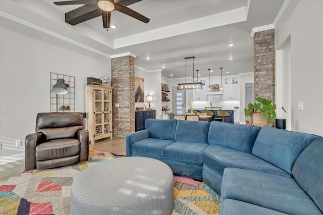 2033 Marsala Dr, Edmond, OK 73034 - living room with ceiling fan, light wood-type flooring, recessed lighting, ornate columns, and a raised ceiling