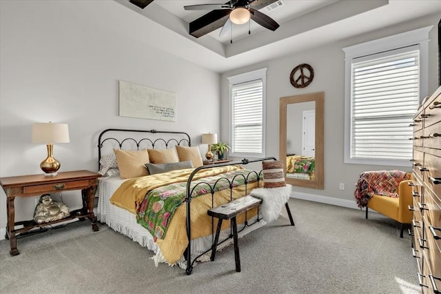 2033 Marsala Dr, Edmond, OK 73034 - bedroom featuring carpet flooring, a tray ceiling, and ceiling fan