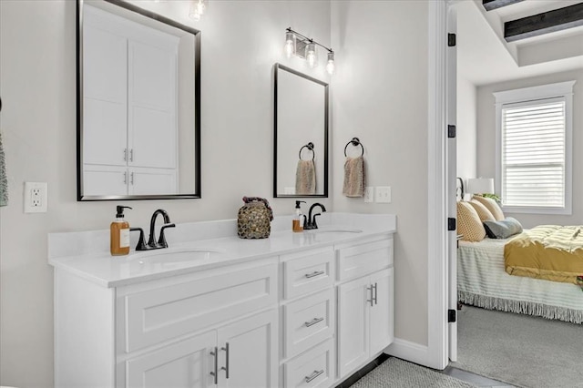 2033 Marsala Dr, Edmond, OK 73034 - ensuite bathroom featuring double vanity and baseboards