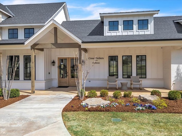 2033 Marsala Dr, Edmond, OK 73034 - doorway to property featuring a porch, french doors, board and batten siding, roof with shingles, and concrete driveway
