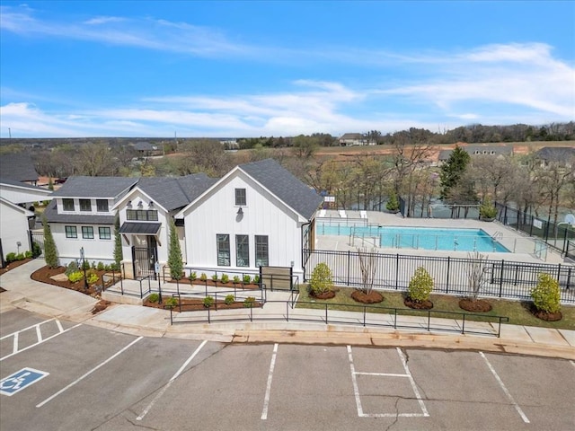 2033 Marsala Dr, Edmond, OK 73034 - view of property with uncovered parking and a community pool