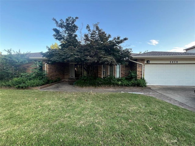 1414 Beverly Hills St, Norman, OK 73072 - view of property hidden behind natural elements with brick siding, a garage, a front yard, and concrete driveway
