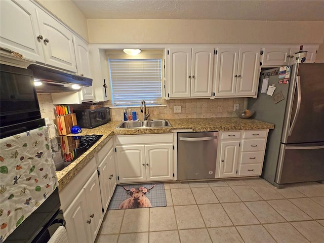 5712 Lawson Ln, Oklahoma City, OK 73132 - kitchen featuring black appliances, white cabinetry, light tile patterned floors, and decorative backsplash
