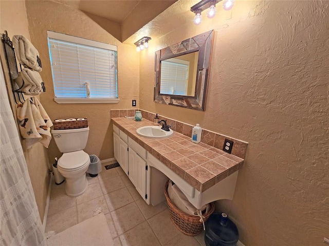 5712 Lawson Ln, Oklahoma City, OK 73132 - bathroom featuring vanity, a textured wall, and tile patterned floors