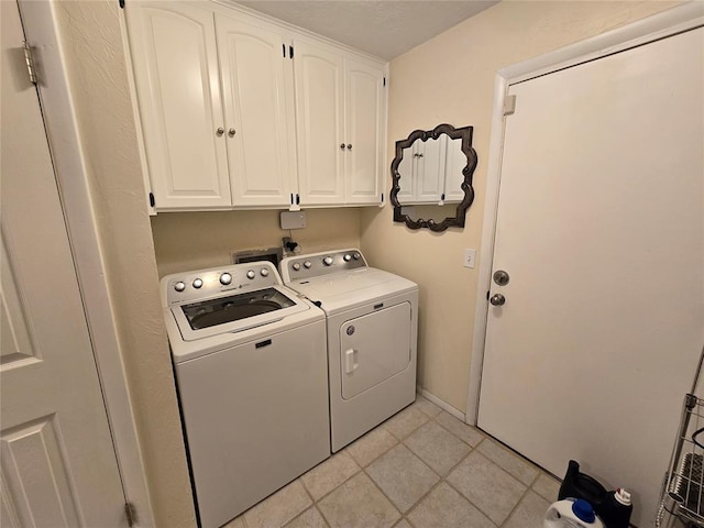 5712 Lawson Ln, Oklahoma City, OK 73132 - washroom featuring cabinet space, washing machine and clothes dryer, and light tile patterned floors