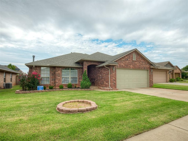5112 NW 163rd St, Edmond, OK 73013 - view of front of home with an attached garage, driveway, a front yard, roof with shingles, and brick siding
