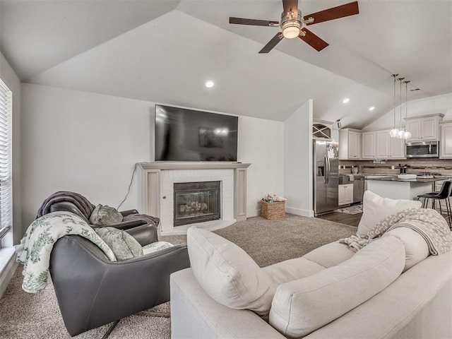 5112 NW 163rd St, Edmond, OK 73013 - living room with vaulted ceiling, a ceiling fan, a fireplace, healthy amount of natural light, and recessed lighting