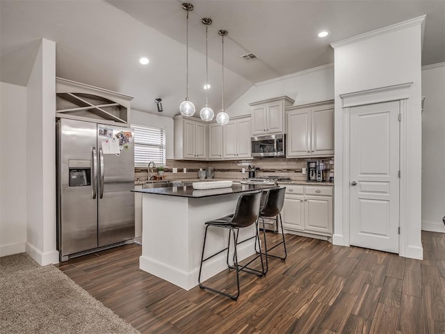 5112 NW 163rd St, Edmond, OK 73013 - kitchen with appliances with stainless steel finishes, lofted ceiling, backsplash, dark wood finished floors, and a center island