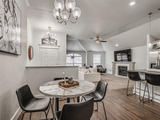 5112 NW 163rd St, Edmond, OK 73013 - dining area with a chandelier, a ceiling fan, dark wood finished floors, a tile fireplace, and recessed lighting