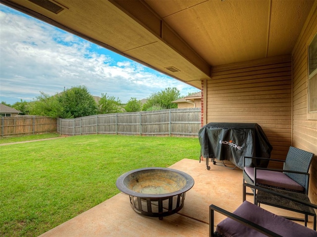 5112 NW 163rd St, Edmond, OK 73013 - fenced backyard with a fire pit, a patio, and a grill