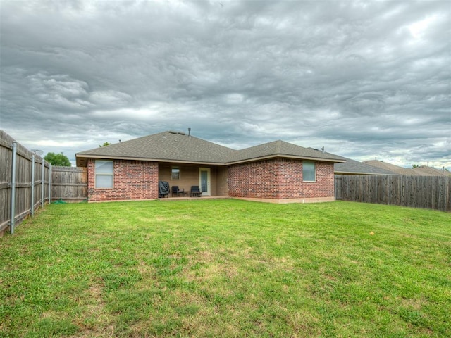 5112 NW 163rd St, Edmond, OK 73013 - rear view of house with brick siding and a fenced backyard