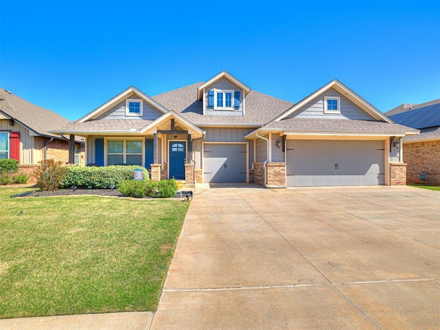 917 NE 34th Ter, Moore, OK 73160 - view of front facade with a front lawn, a shingled roof, a garage, driveway, and brick siding