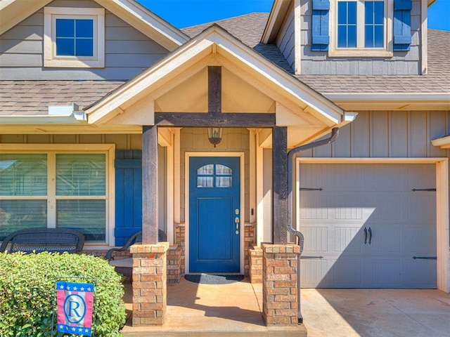 917 NE 34th Ter, Moore, OK 73160 - doorway to property with board and batten siding, roof with shingles, driveway, and an attached garage