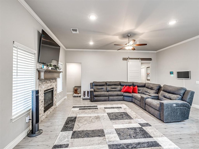 917 NE 34th Ter, Moore, OK 73160 - living room featuring a ceiling fan, light wood-style flooring, a fireplace, recessed lighting, and crown molding