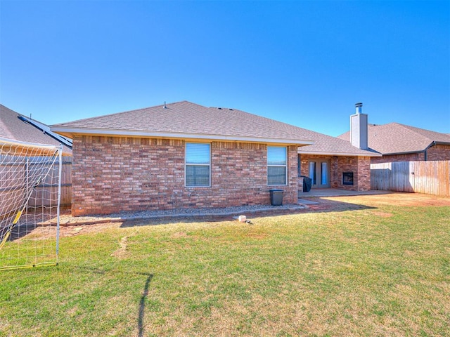 917 NE 34th Ter, Moore, OK 73160 - rear view of property with brick siding, a chimney, and roof with shingles