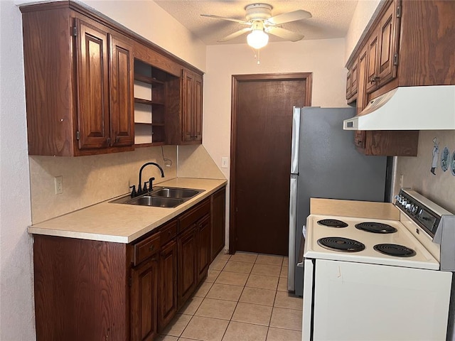 8300 NW 10th St Unit 140, Oklahoma City, OK 73127 - kitchen featuring white range with electric cooktop, under cabinet range hood, a ceiling fan, light tile patterned flooring, and light countertops
