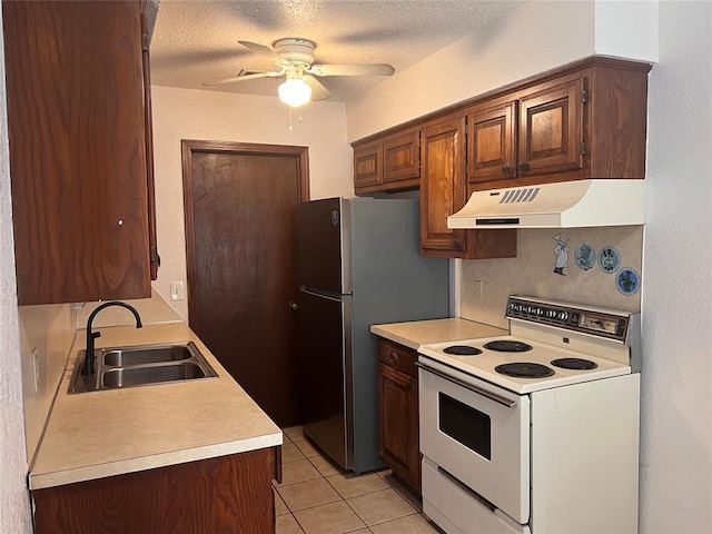 8300 NW 10th St Unit 140, Oklahoma City, OK 73127 - kitchen with electric stove, under cabinet range hood, ceiling fan, light countertops, and a textured ceiling