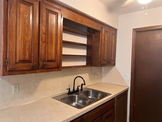 8300 NW 10th St Unit 140, Oklahoma City, OK 73127 - kitchen with light countertops, tasteful backsplash, open shelves, a textured ceiling, and ceiling fan