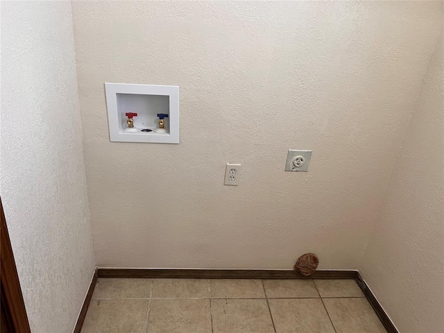 8300 NW 10th St Unit 140, Oklahoma City, OK 73127 - washroom with hookup for an electric dryer, hookup for a washing machine, and tile patterned flooring