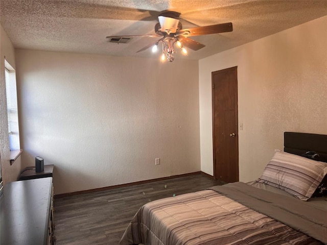 8300 NW 10th St Unit 140, Oklahoma City, OK 73127 - bedroom with wood finished floors, a textured ceiling, a textured wall, and a ceiling fan