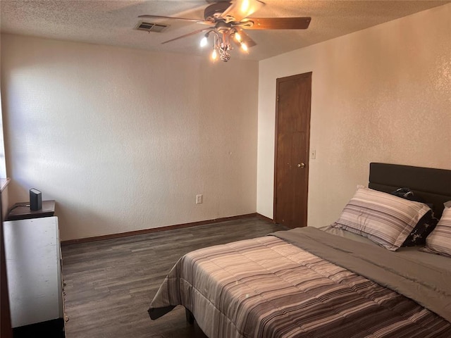 8300 NW 10th St Unit 140, Oklahoma City, OK 73127 - bedroom with wood finished floors, a textured wall, a ceiling fan, and a textured ceiling