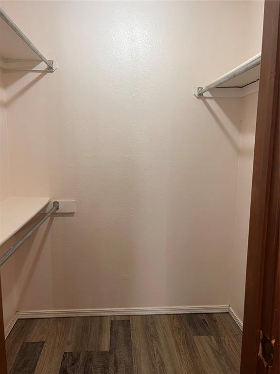 8300 NW 10th St Unit 140, Oklahoma City, OK 73127 - walk in closet featuring dark wood-style flooring