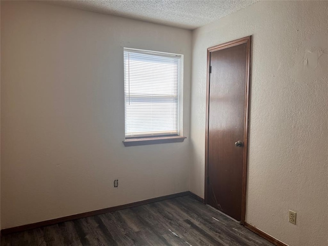 8300 NW 10th St Unit 140, Oklahoma City, OK 73127 - empty room with dark wood finished floors and a textured ceiling