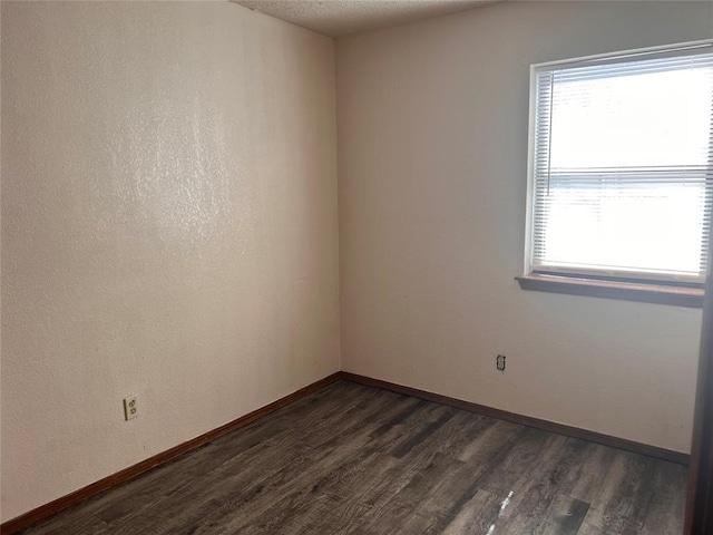 8300 NW 10th St Unit 140, Oklahoma City, OK 73127 - spare room with dark wood-style flooring