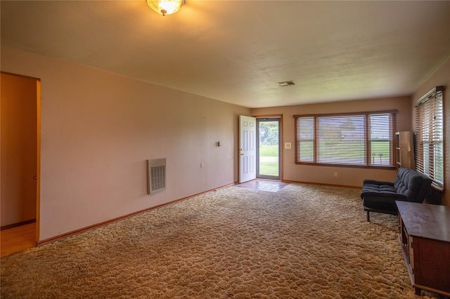 423 N Missouri St, Weatherford, OK 73669 - unfurnished living room featuring baseboards and carpet