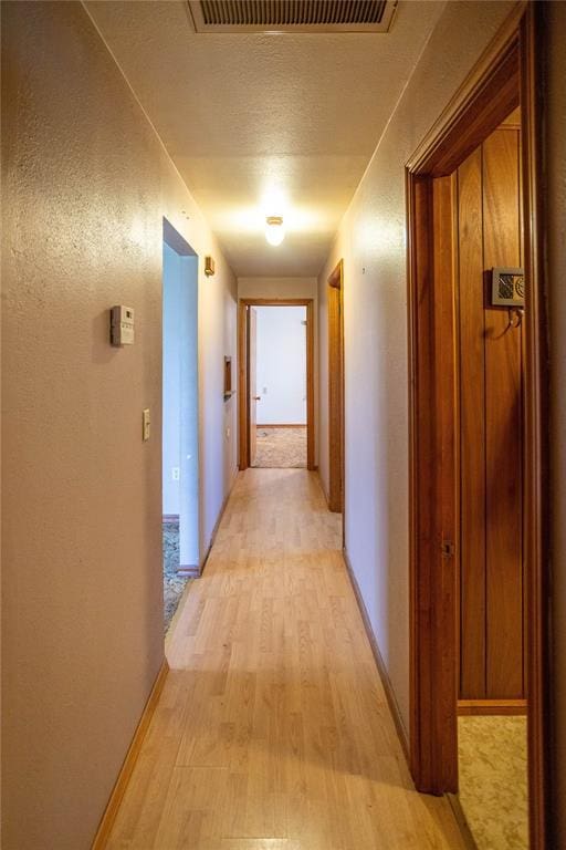 423 N Missouri St, Weatherford, OK 73669 - hallway with light wood-type flooring and a textured ceiling