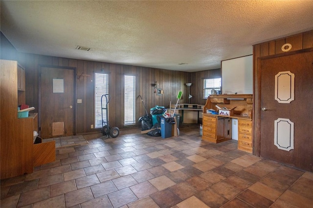 423 N Missouri St, Weatherford, OK 73669 - foyer entrance featuring wooden walls and a textured ceiling
