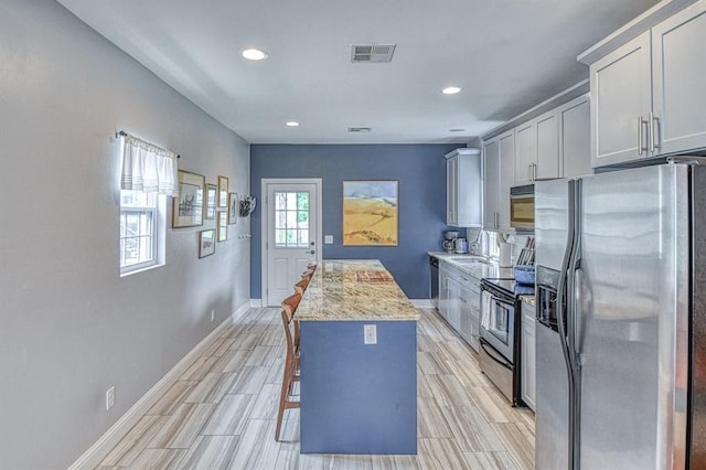 1621 NW 18th St, Oklahoma City, OK 73106 - kitchen featuring stainless steel appliances, recessed lighting, a center island, and wood finish floors
