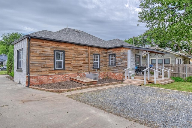 1621 NW 18th St, Oklahoma City, OK 73106 - view of front facade with a shingled roof and stone siding