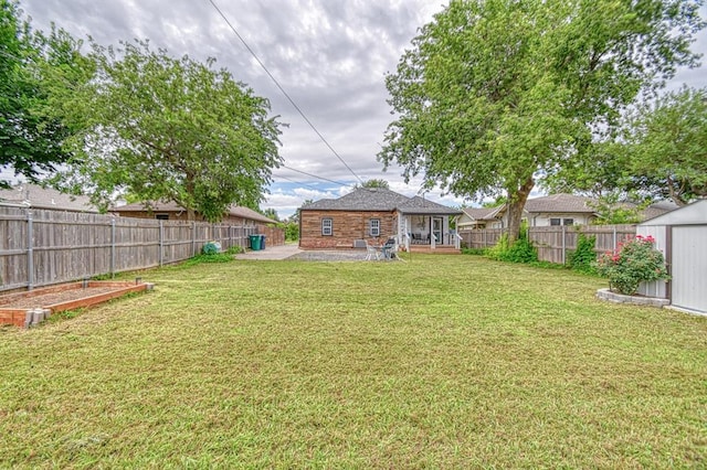 1621 NW 18th St, Oklahoma City, OK 73106 - fenced backyard with a patio and a storage unit