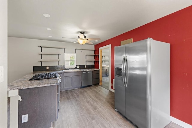 4504 N Grove Ave, Warr Acres, OK 73122 - kitchen featuring stainless steel appliances, open shelves, light wood-type flooring, a ceiling fan, and light countertops